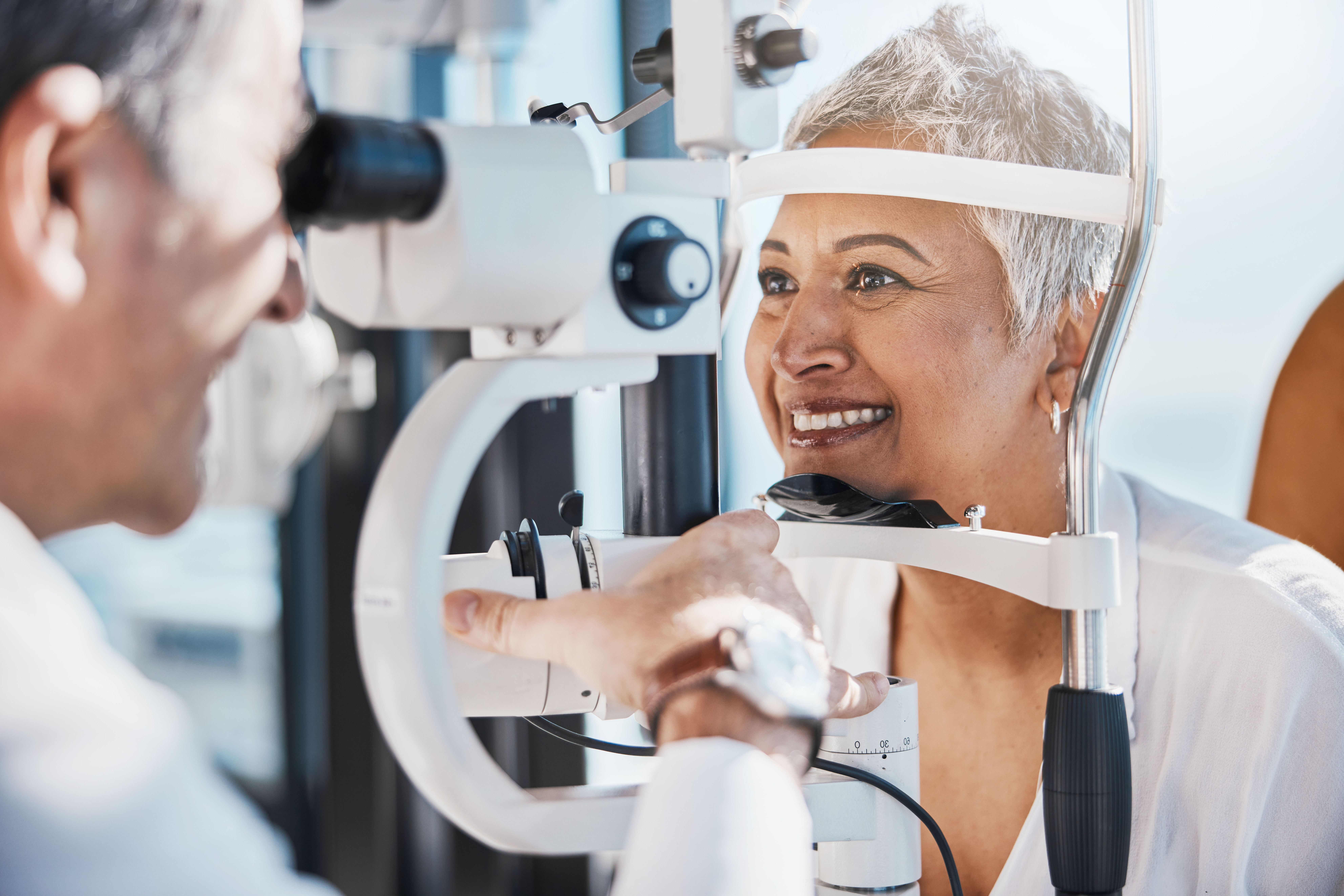 Senior Woman, Eye Exam And Optometrist With Medical Eyes Test At Doctor Consultation. Vision, Healthcare Focus And Old Female Patient With Consulting Wellness Expert For Lens And Glasses Check